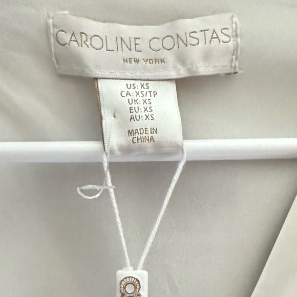 NWT CAROLINE CONSTAS BLACK AND WHITE TROPICAL GEOMETRIC KEYHOLE CUT OUT BLOUSE - Picture 3 of 5